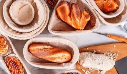 Pães e massa de pão descansando em cestos sob uma mesa